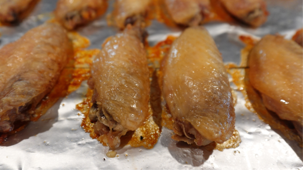 Completed crispy oven baked wings on a pan.